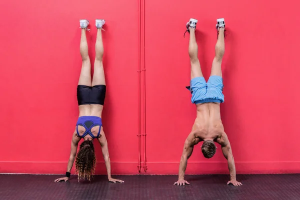 Couple doing handstand exercises — Stock Photo, Image