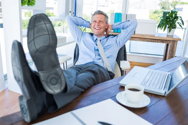 Businessman relaxing in a swivel chair — Stock Photo, Image