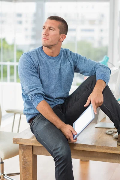 Young creative businessman holding a tablet — Stock Photo, Image