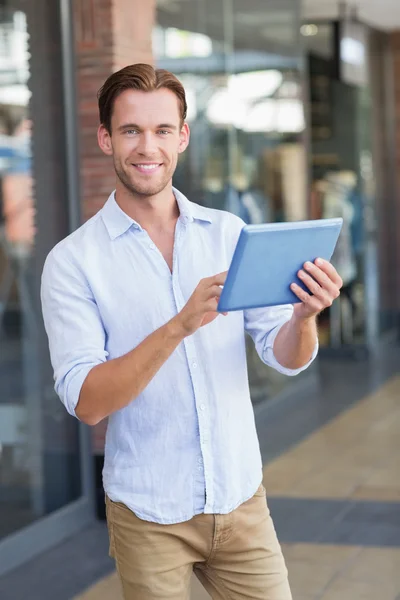 Um homem sorridente feliz usando seu tablet — Fotografia de Stock