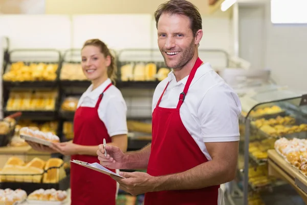 Portrait of a two smiling bakers looking at camera — Stock Photo, Image