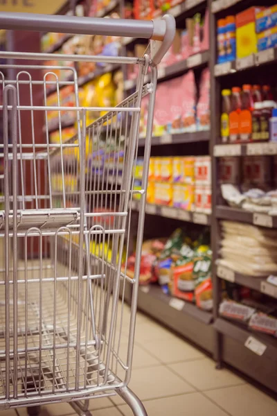 Empty trolley in supermarket Stock Image