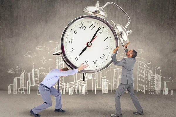 Businesspeople holding alarm clock — Stock Photo, Image