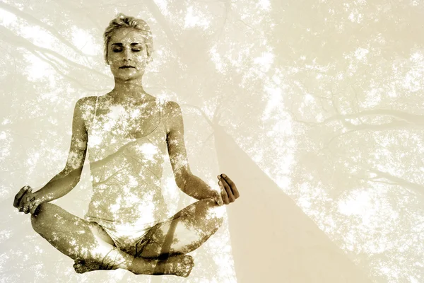 Woman sitting in lotus pose — Stock Photo, Image