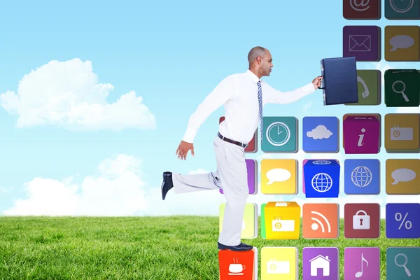 Composite image of businessman running with briefcase — Stock Photo, Image