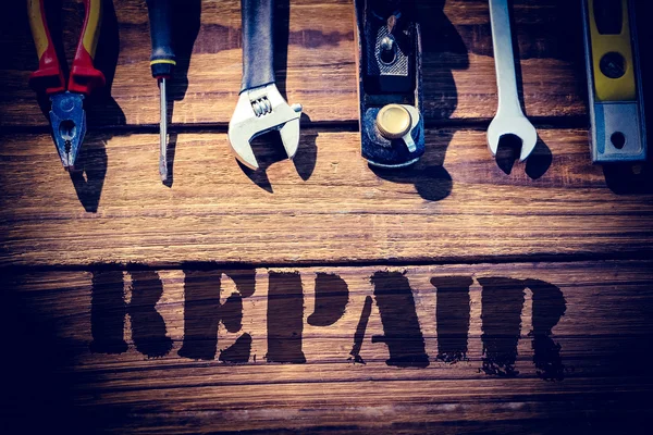 Repair against desk with tools — Stock Photo, Image