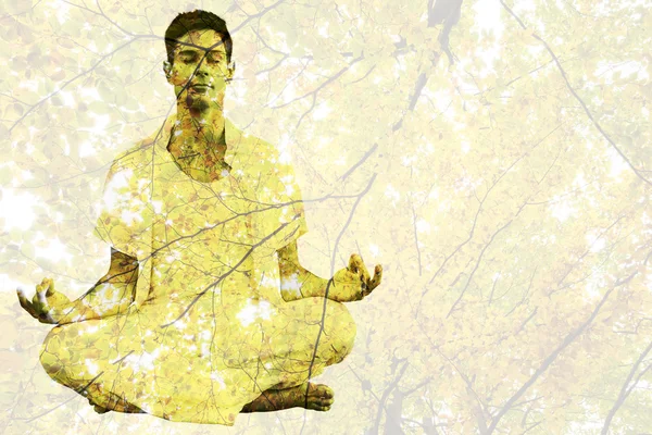 Man in white meditating in lotus pose — Stock Photo, Image