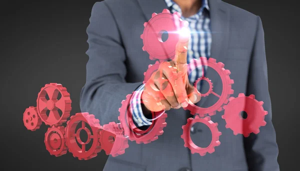 Businessman pointing on cogs — Stock Photo, Image