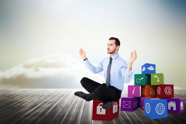 Relaxed businessman sitting in lotus pose — Stock Photo, Image