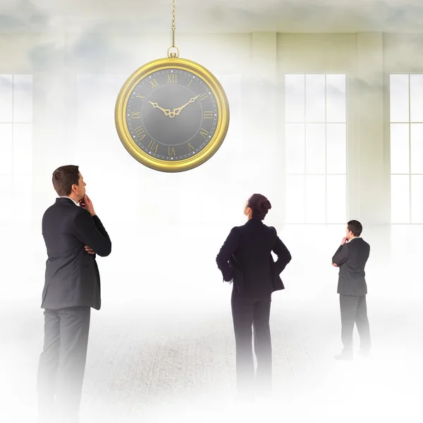 Business people looking on clock — Stock Photo, Image