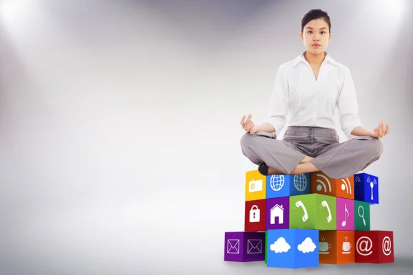 Businesswoman sitting in lotus pose — Stock Photo, Image