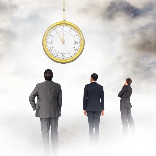 Businessmen looking on clock — Stock Photo, Image