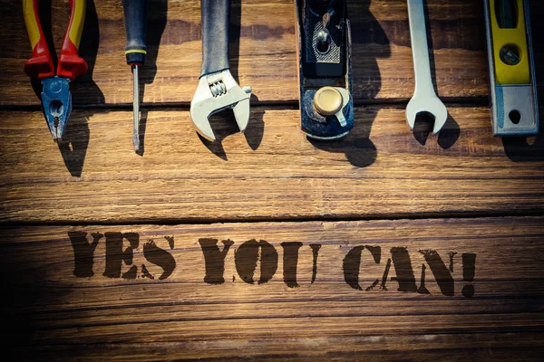 Yes you can! against desk with tools — Stock Photo, Image