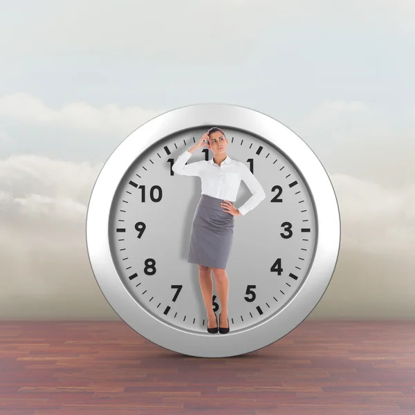 Focused businesswoman against clouds — Stock Photo, Image