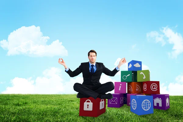 Calm businessman sitting in lotus pose — Stock Photo, Image