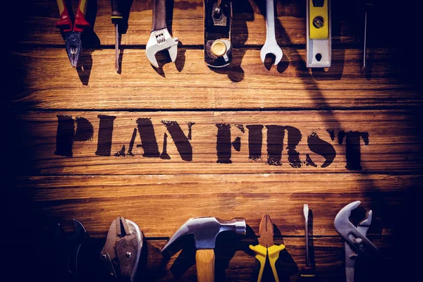 Plan first against desk with tools — Stock Photo, Image