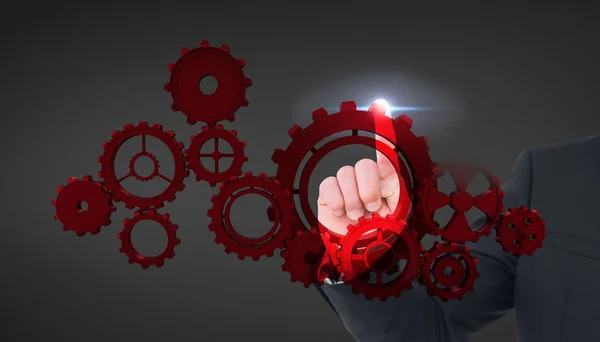 Businessman pointing on cogs — Stock Photo, Image