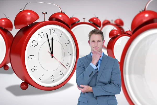 Thinking businessman with clocks — Stock Photo, Image