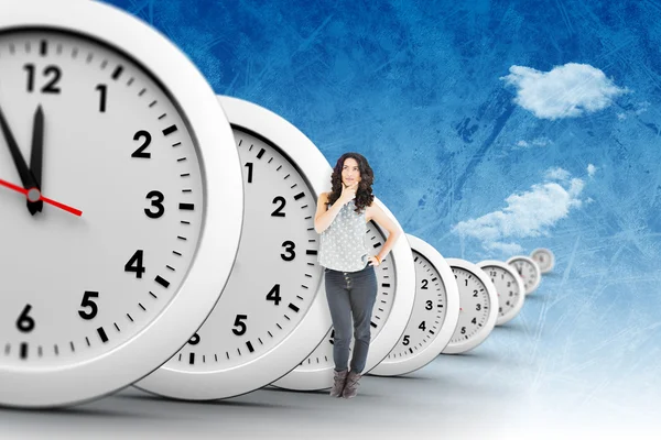 Thoughtful woman with clocks — Stock Photo, Image