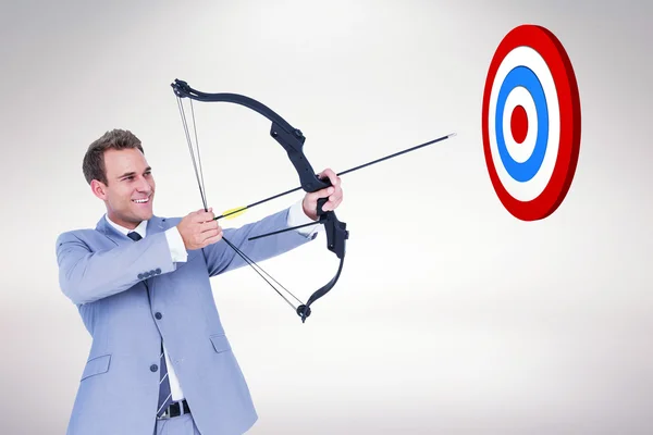 Businessman shooting arrow — Stock Photo, Image