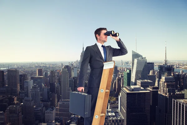 Businessman looking on ladder — Stock Photo, Image