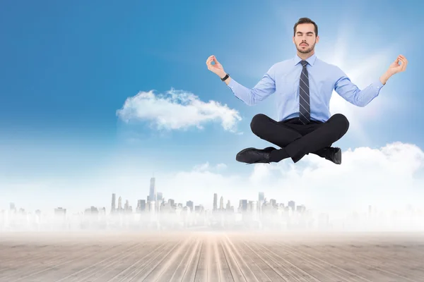 Businessman sitting in lotus pose — Stock Photo, Image