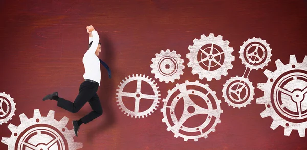 Jumping businessman with cogs — Stock Photo, Image