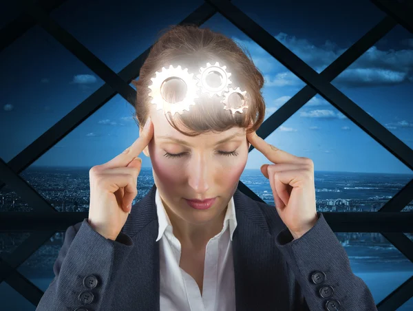 Stressed businesswoman with fingers on temple — Stock Photo, Image