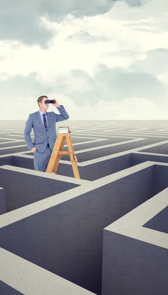 Businessman looking on ladder — Stock Photo, Image