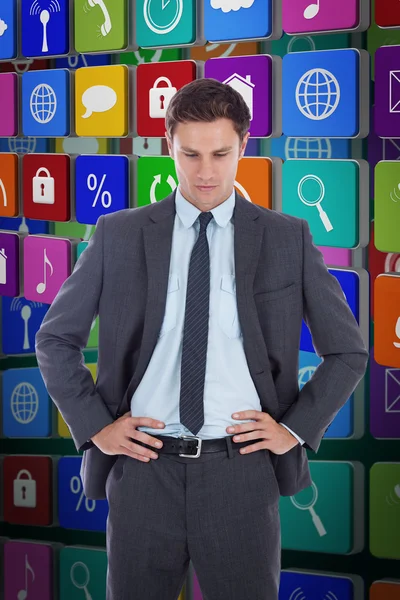 Serious businessman with hands on hips — Stock Photo, Image