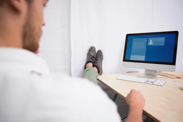 Businessman with legs crossed on office desk — Stock Photo, Image