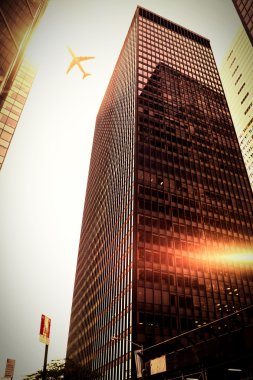 flying airplane and skyscrapers clipart