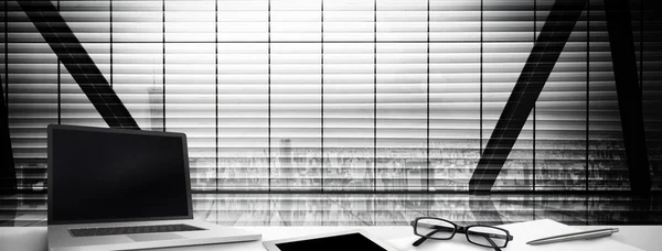 Desk against window overlooking city — Stock Photo, Image