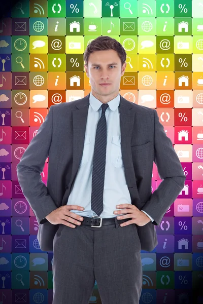 Serious businessman with hands on hips — Stock Photo, Image