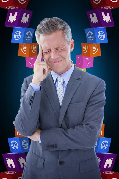 Businessman with headache against blue — Stock Photo, Image