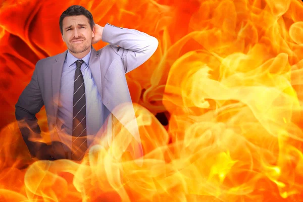 Thinking businessman against fire — Stock Photo, Image