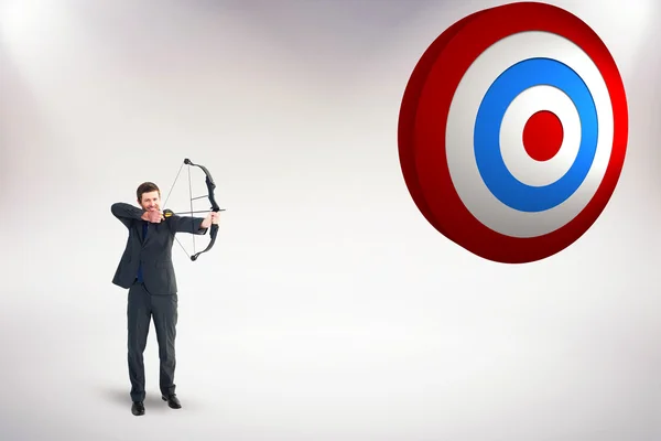 Businessman shooting bow — Stock Photo, Image