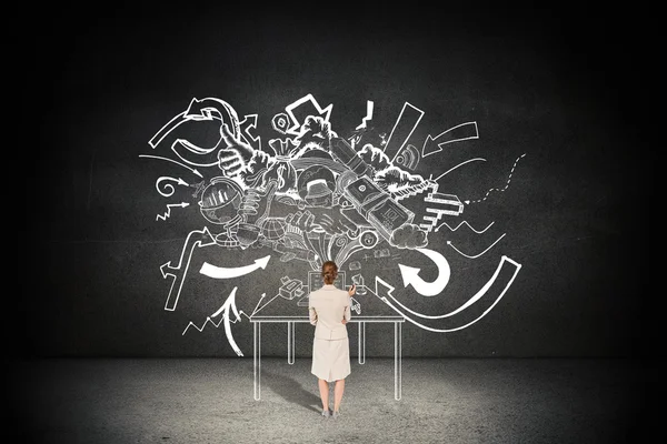 Thinking businesswoman against black wall — Stock Photo, Image
