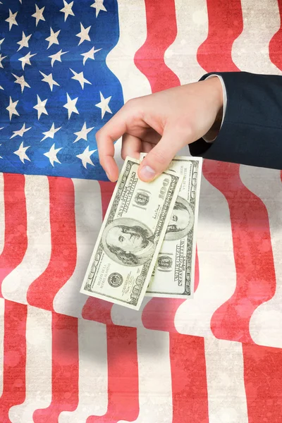 Composite image of hand holding hundred dollar bills — Stock Photo, Image