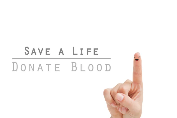 Doação de sangue contra o dedo com rosto sorridente — Fotografia de Stock