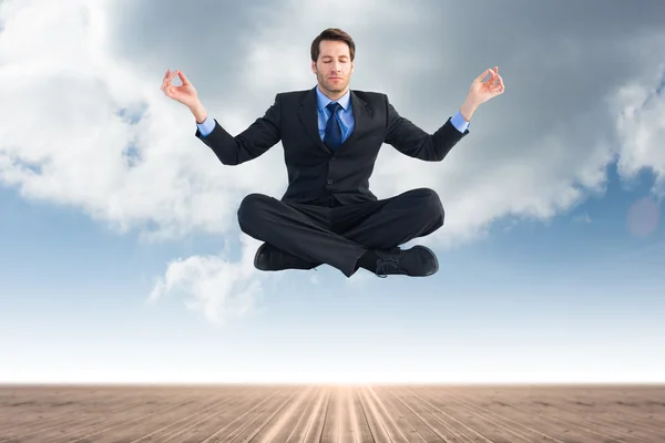 Businessman sitting in lotus pose — Stock Photo, Image