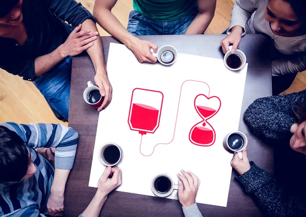 People sitting around table drinking coffee — Stock Photo, Image