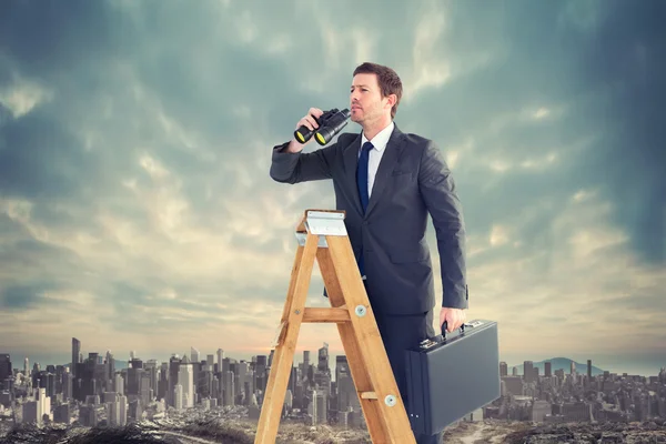 Businessman looking on ladder — Stock Photo, Image