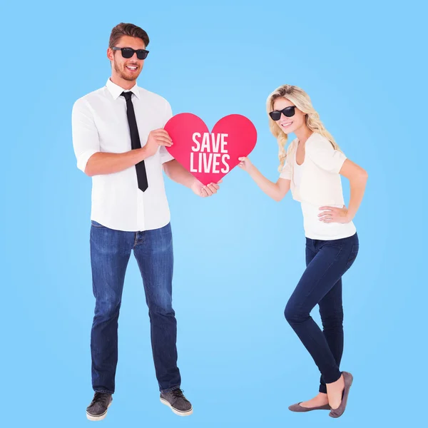 Couple holding red heart together — Stock Photo, Image