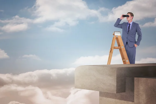 Businessman looking on ladder — Stock Photo, Image