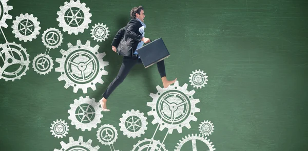 Leaping businessman with cogs — Stock Photo, Image