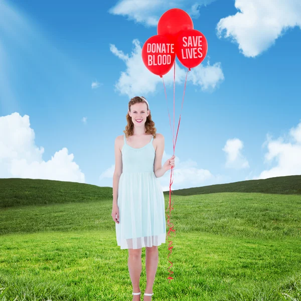 Woman holding balloons — Stock Photo, Image