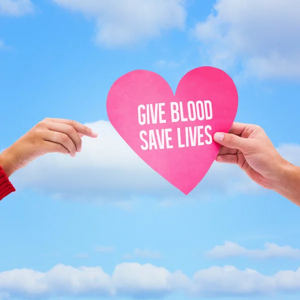 Manos sosteniendo la tarjeta de donación de sangre — Foto de Stock