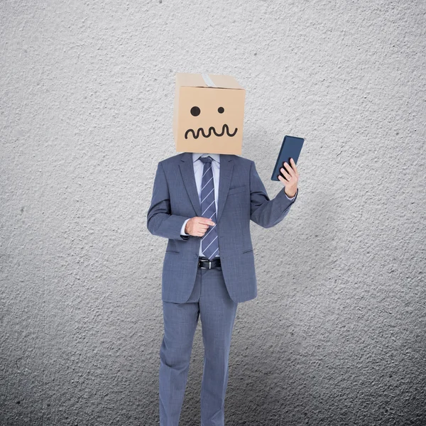 Anonymous businessman standing with box on head — Stock Photo, Image