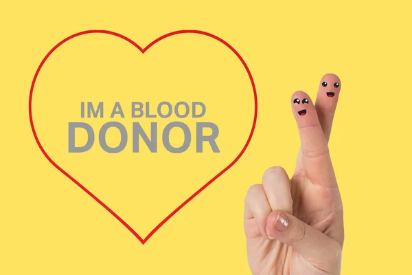 Blood donation against yellow vignette — Stock Photo, Image